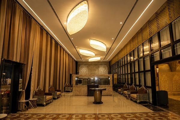 Grand entrance promenade and designer pendant illumination in the foyer