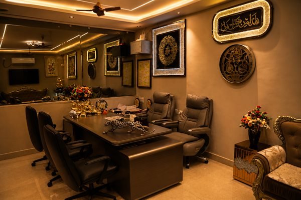 On-site management consultation office with executive desk and conference seating